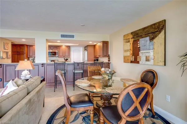 a kitchen with stainless steel appliances granite countertop a stove a sink dishwasher and a refrigerator with wooden cabinets