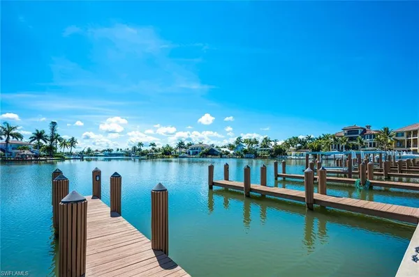 a view of a lake with boats and trees in the background