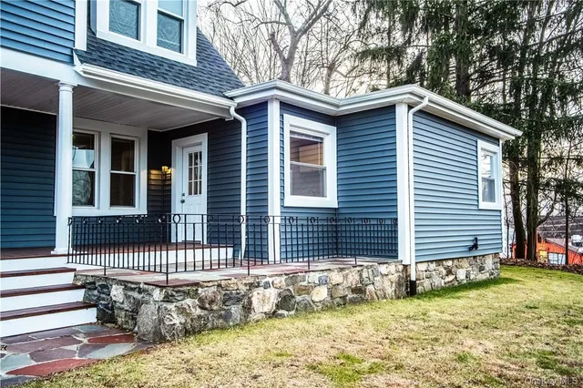 a front view of a house with a garden
