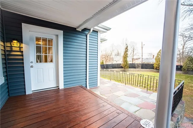 a view of a room with wooden floor and iron stairs