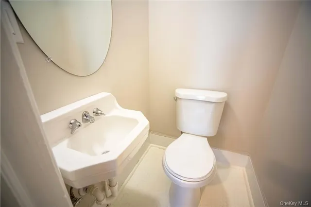 a white toilet sitting next to a bathroom sink