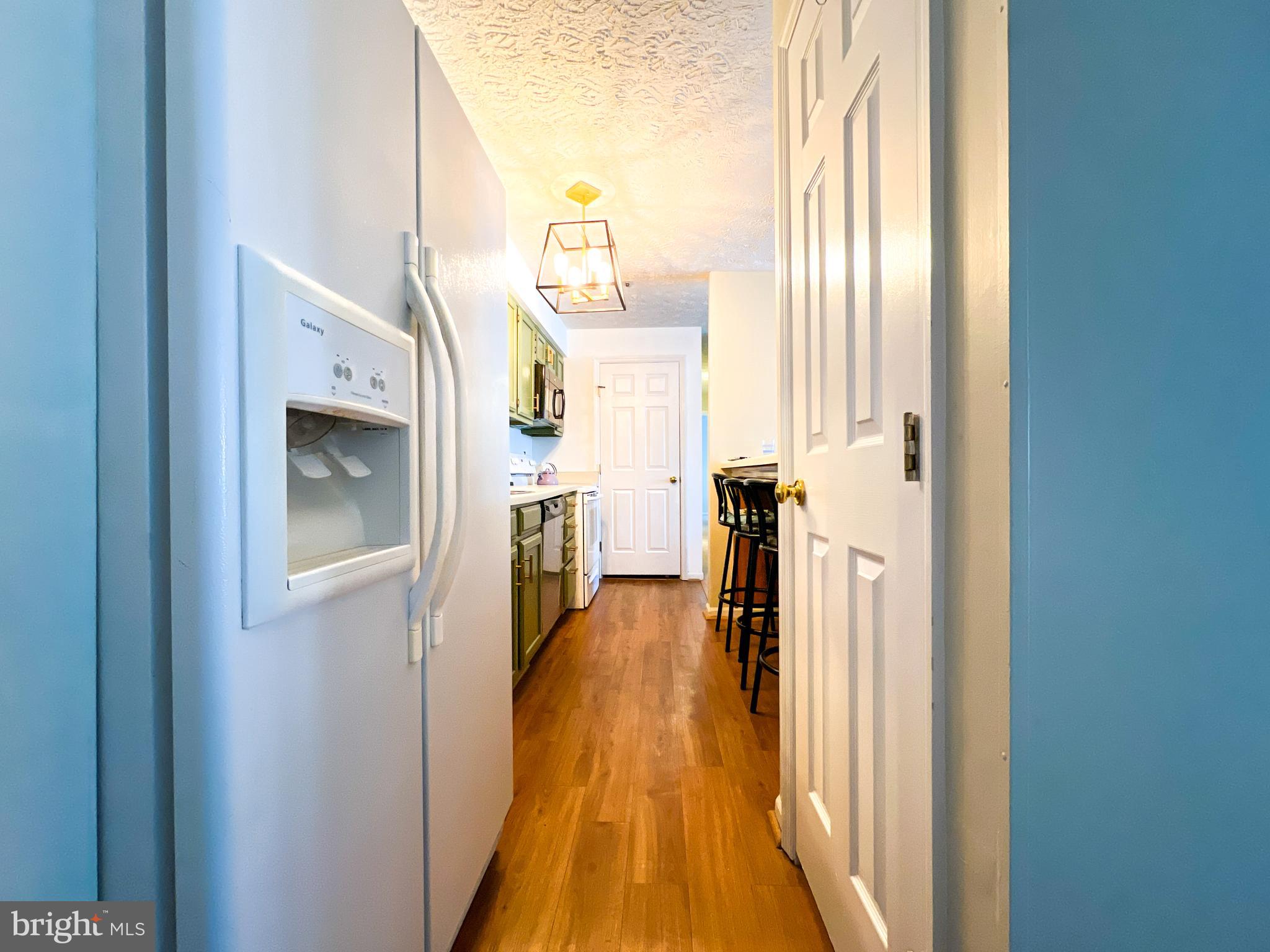 705 Deering Road, Unit 5E Pasadena, MD 21122 - Photo 4 of 19 a view of a hallway with wooden floor and windows