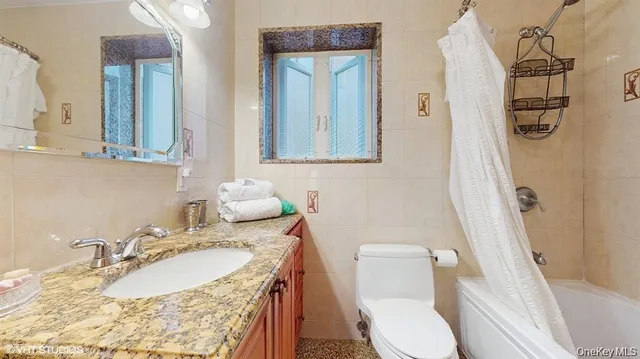 a bathroom with a sink toilet and mirror