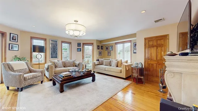 a living room with furniture and a chandelier