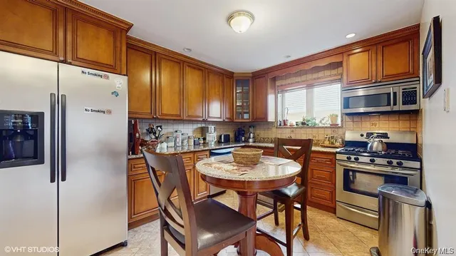 a kitchen with stainless steel appliances granite countertop a stove a sink dishwasher and cabinets with wooden floor