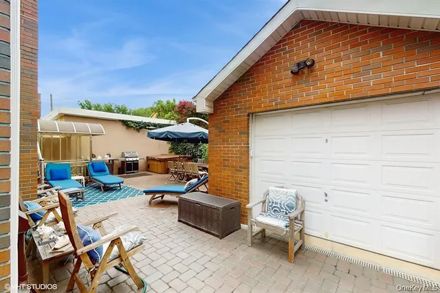 a backyard of a house with outdoor seating