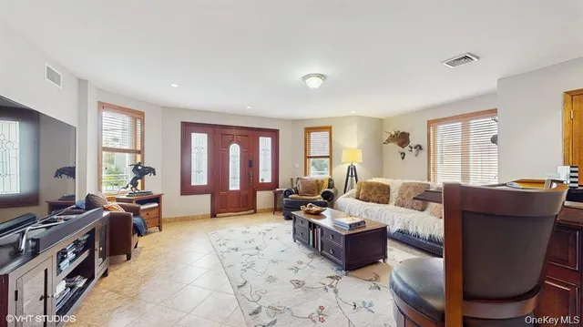 a living room with furniture and a flat screen tv