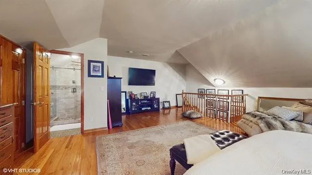 a bedroom with furniture and a wooden floor