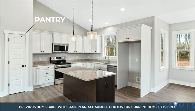 a kitchen with stainless steel appliances granite countertop a refrigerator a sink dishwasher a stove with white cabinets