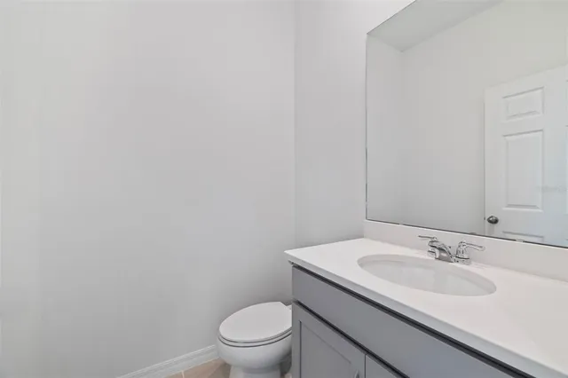 a bathroom with a sink toilet and a mirror