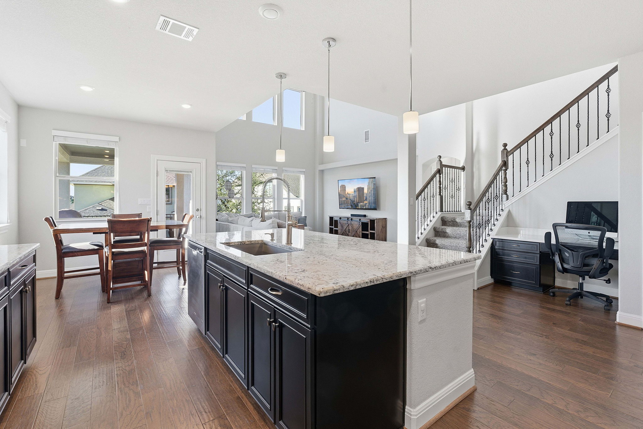 a kitchen with counter top space and wooden floor