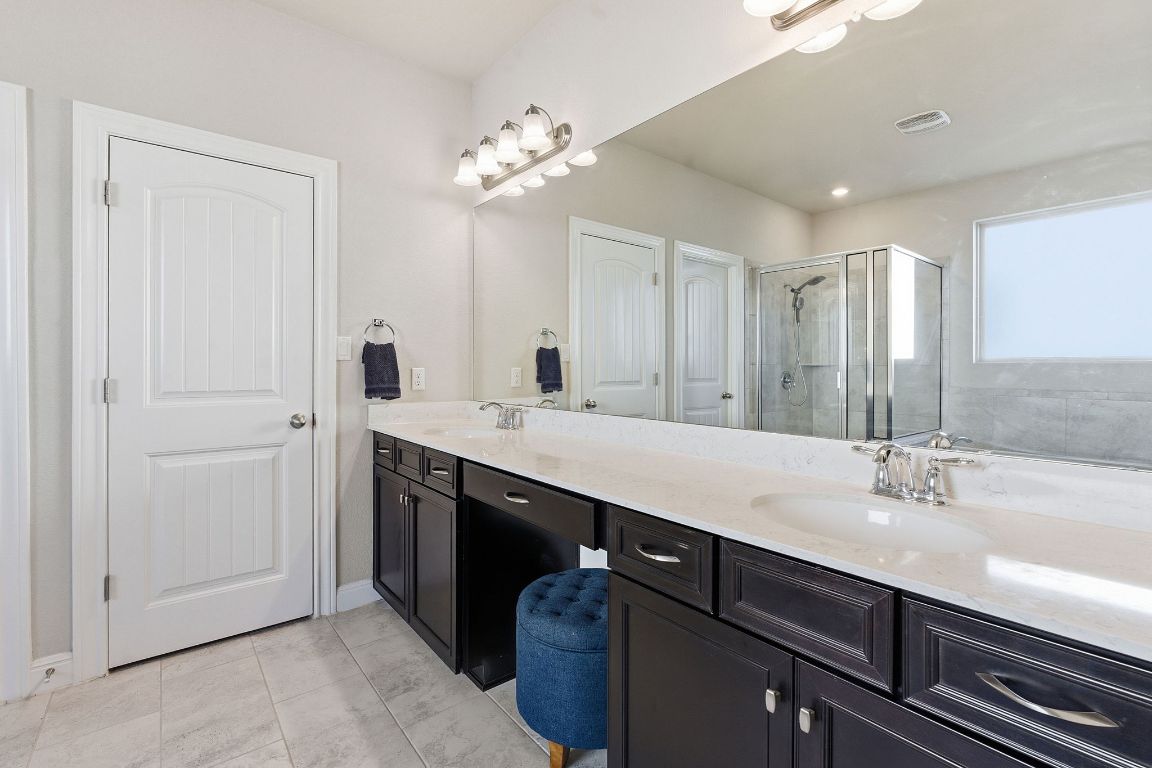 15604 Cabrillo Way Austin, TX 78738 - Photo 10 of 33 a bathroom with a double vanity sink a vanity and mirror
