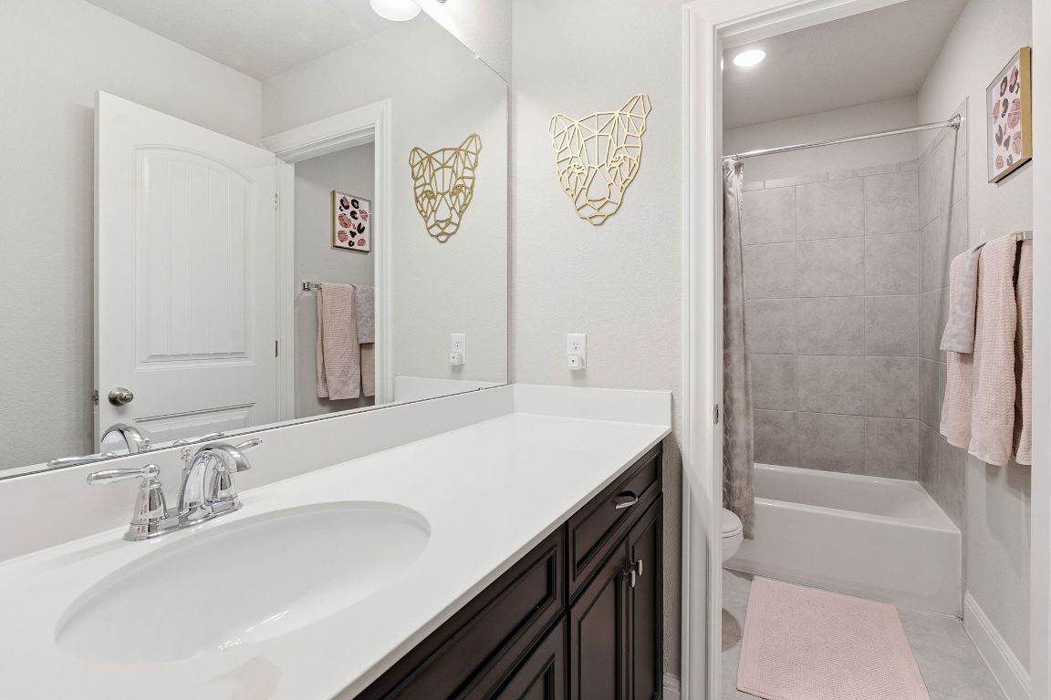 15604 Cabrillo Way Austin, TX 78738 - Photo 14 of 33 a bathroom with a granite countertop sink a toilet and shower