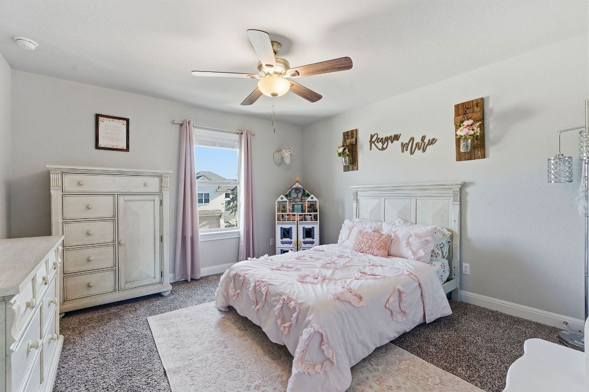 15604 Cabrillo Way Austin, TX 78738 - Photo 15 of 33 a bedroom with a large bed and a chandelier