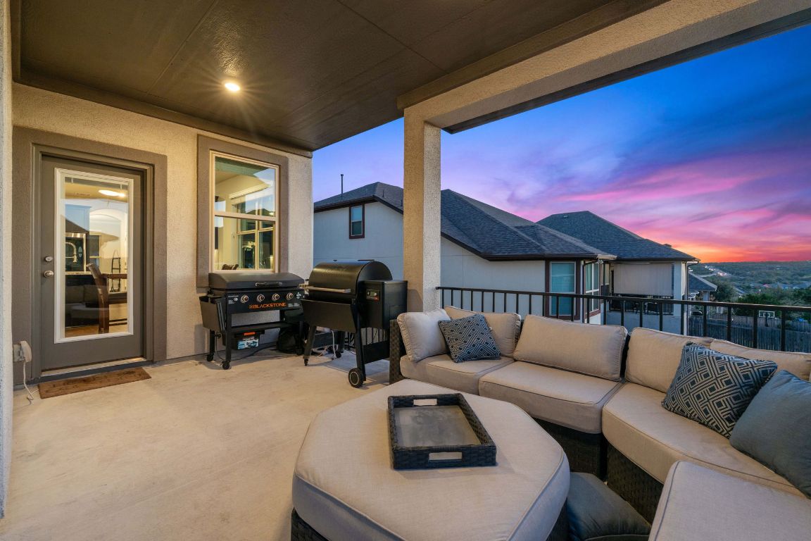 15604 Cabrillo Way Austin, TX 78738 - Photo 29 of 33 a living room with furniture a fireplace and a flat screen tv