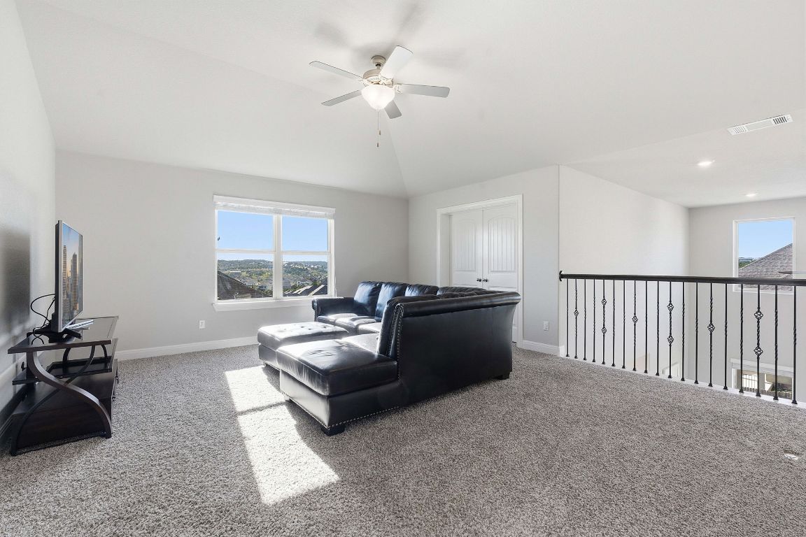 15604 Cabrillo Way Austin, TX 78738 - Photo 8 of 33 a living room with furniture a window and a flat screen tv