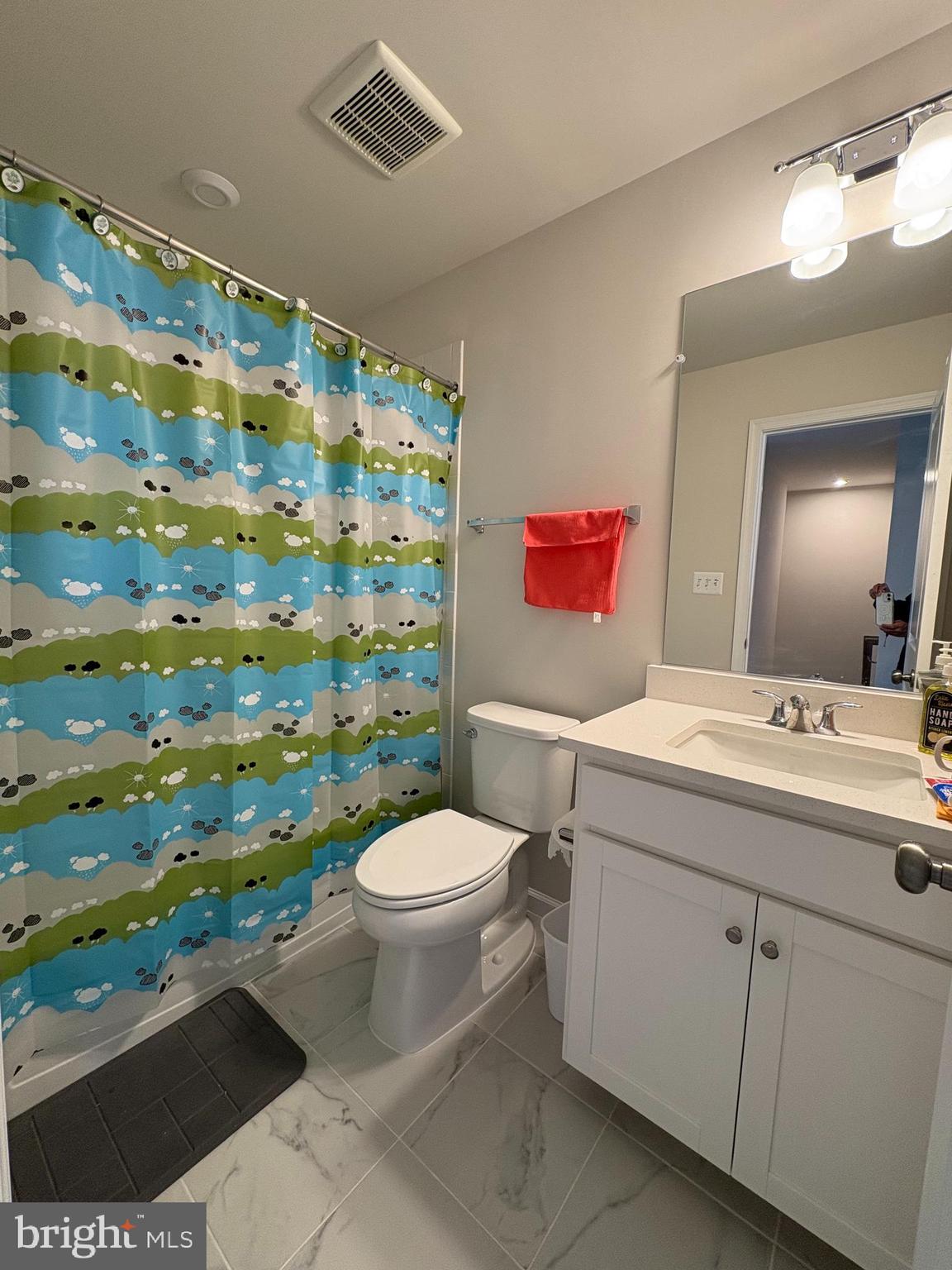 480 National Street Ranson, WV 25438 - Photo 18 of 24 a bathroom with a sink a toilet and shower curtain