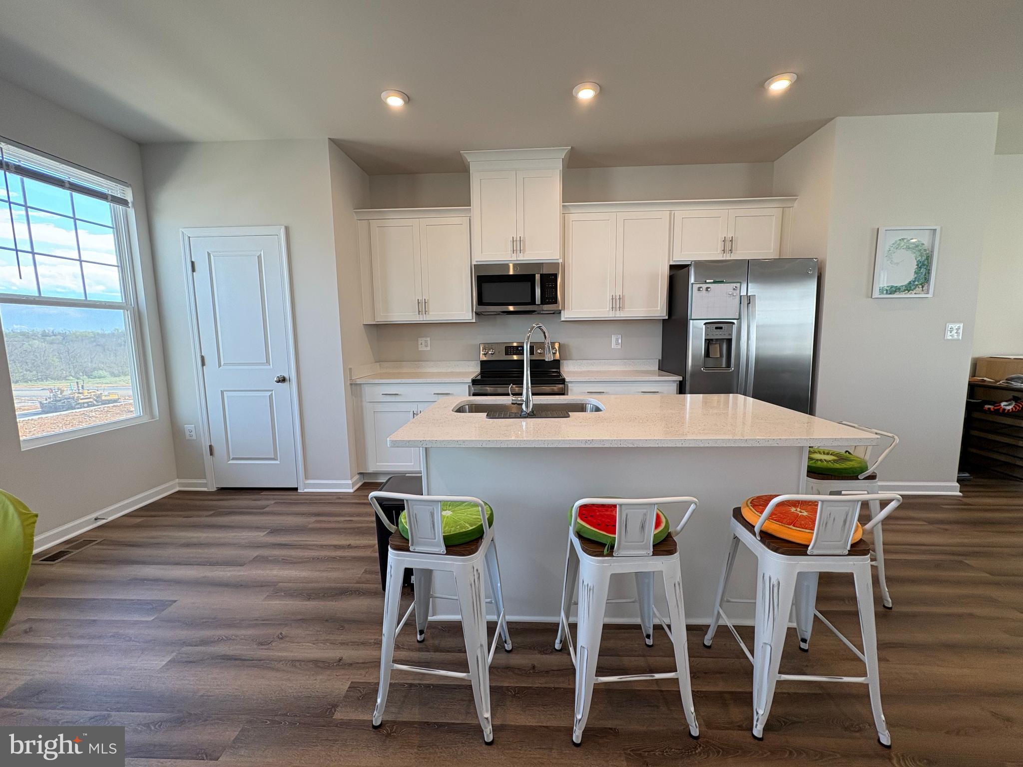480 National Street Ranson, WV 25438 - Photo 2 of 24 a kitchen with kitchen island wooden cabinets and refrigerator