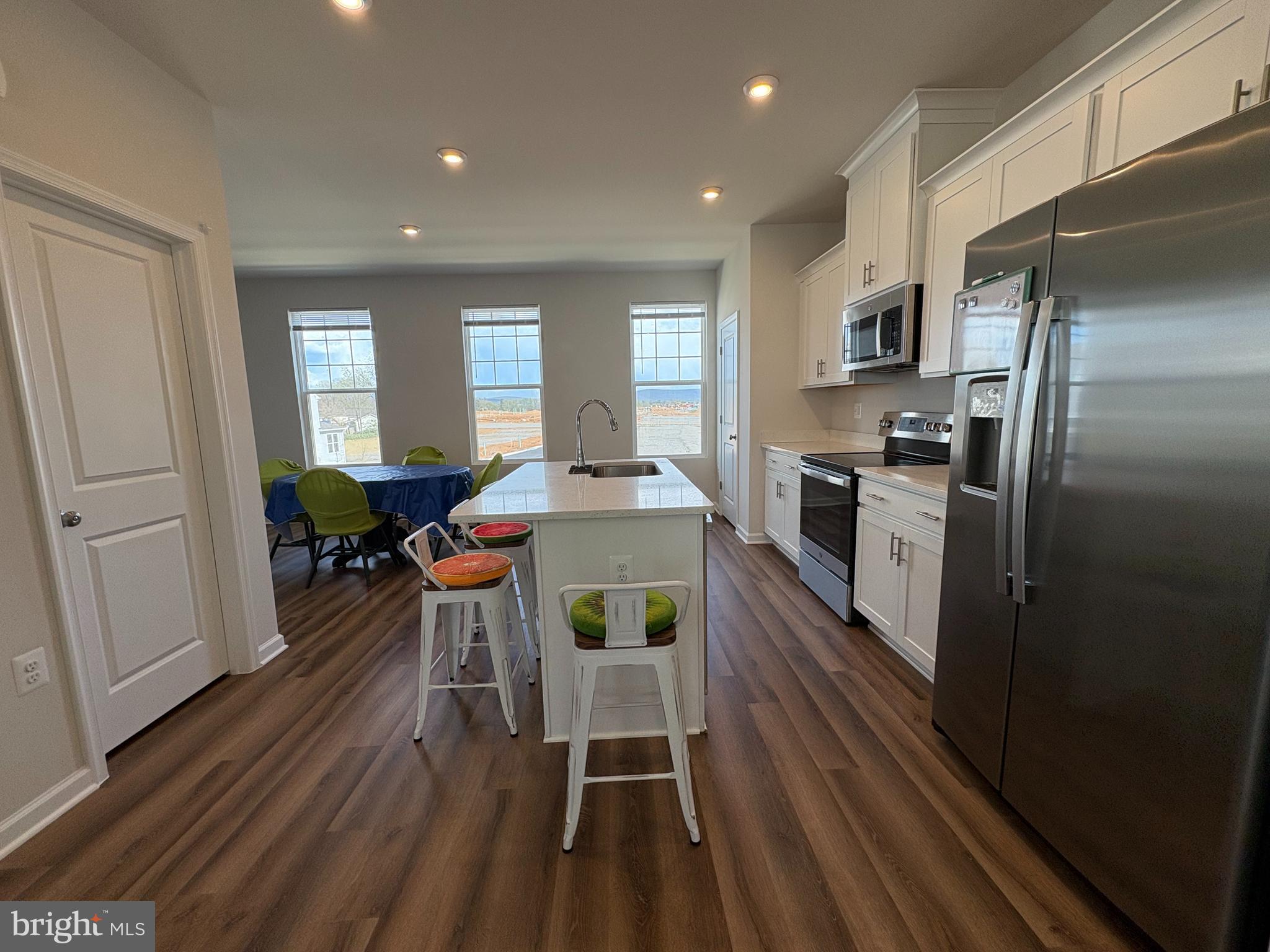 480 National Street Ranson, WV 25438 - Photo 3 of 24 a kitchen with stainless steel appliances a dining table chairs stove refrigerator and cabinets