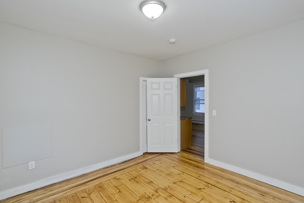 202 Oakland Street Springfield, MA 01108 - Photo 14 of 39 a view of an empty room with wooden floor