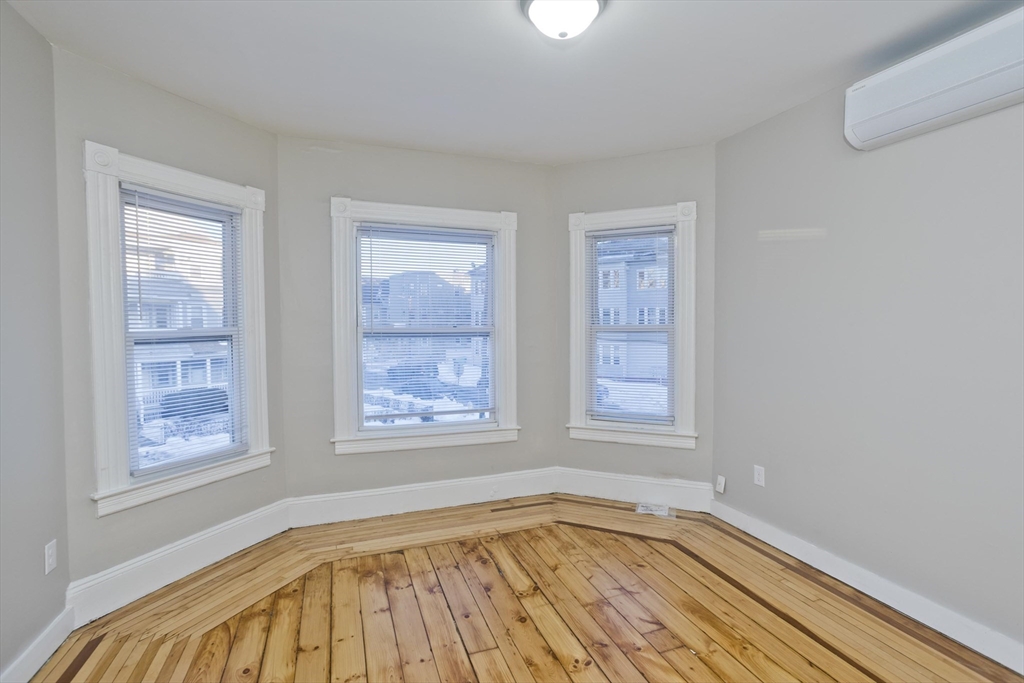 202 Oakland Street Springfield, MA 01108 - Photo 20 of 39 a view of an empty room with wooden floor and a window