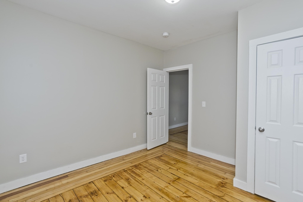 202 Oakland Street Springfield, MA 01108 - Photo 21 of 39 a view of an empty room and wooden floor