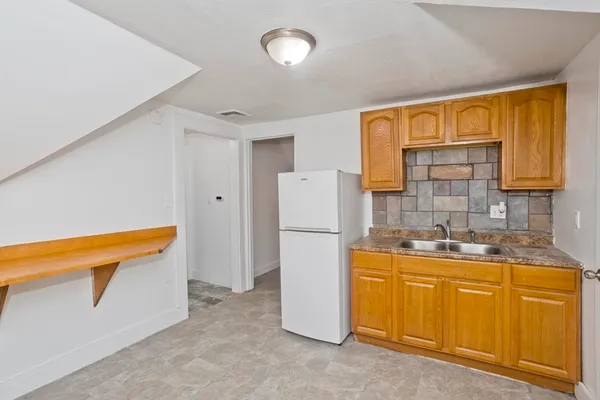 a kitchen with a sink and refrigerator