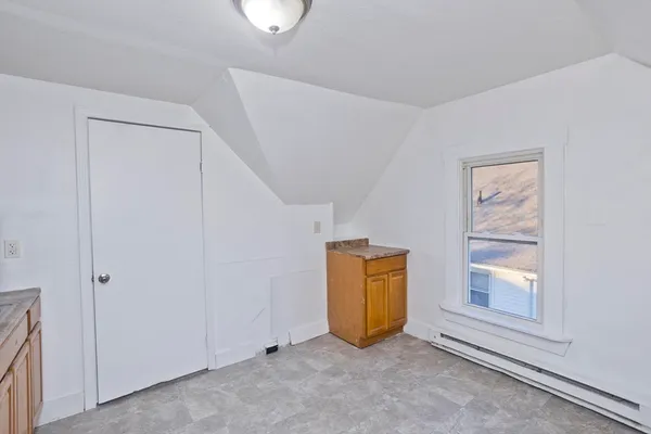 an empty room with windows and closet