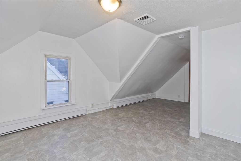 202 Oakland Street Springfield, MA 01108 - Photo 29 of 39 an empty room with cabinet and mirrors