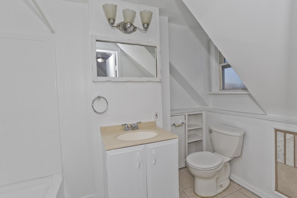 202 Oakland Street Springfield, MA 01108 - Photo 35 of 39 a bathroom with a toilet sink and mirror