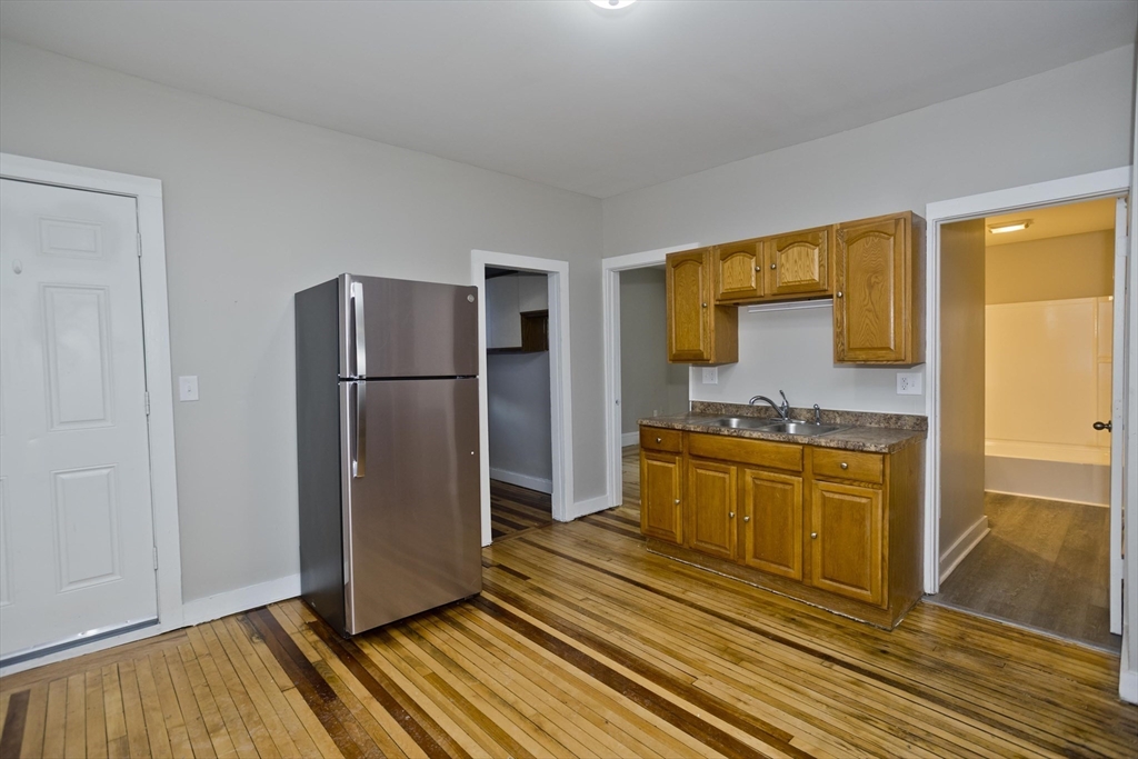 202 Oakland Street Springfield, MA 01108 - Photo 5 of 39 a kitchen with stainless steel appliances granite countertop a refrigerator and a stove top oven
