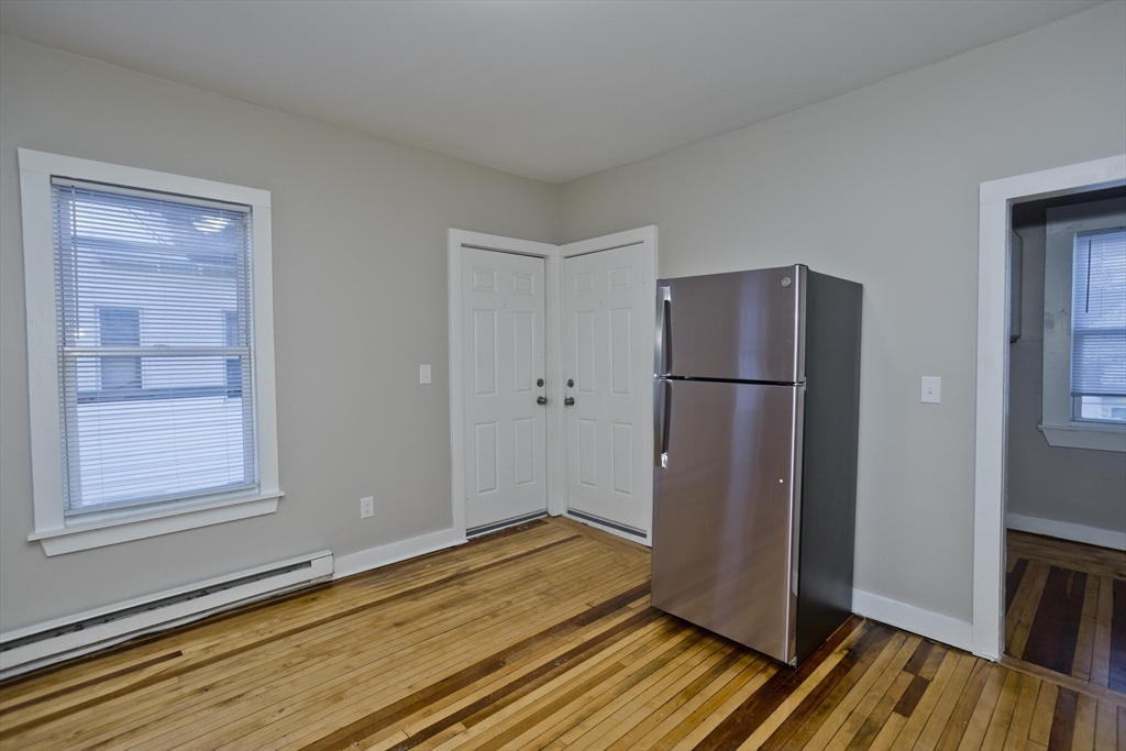 202 Oakland Street Springfield, MA 01108 - Photo 6 of 39 a view of a kitchen with wooden floor and a refrigerator