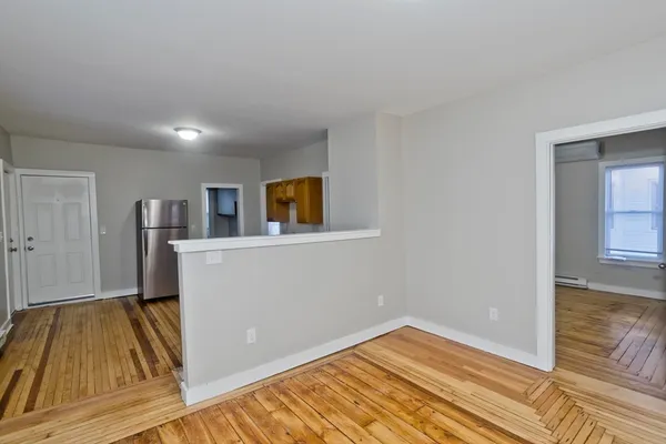 a view of a room with wooden floor and workspace