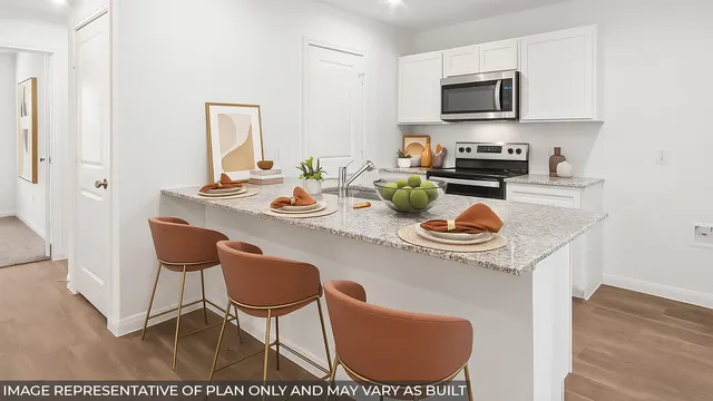 a kitchen with a sink a stove and chairs with wooden floor