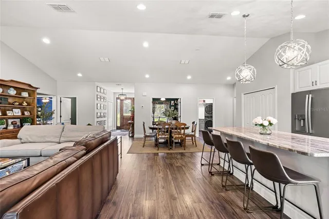 a large kitchen with a table and chairs
