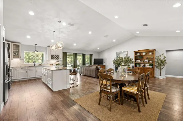 a view of a dining room with furniture and wooden floor