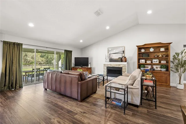 a living room with furniture a fireplace and a flat screen tv