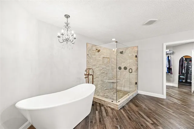 a bathroom with a shower a bathtub and a toilet