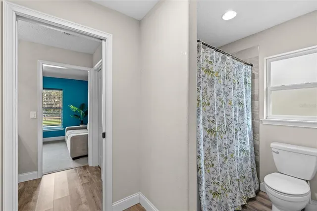 a bathroom with a toilet and a shower