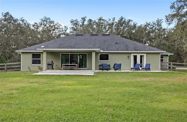 a house view with a sitting space and garden