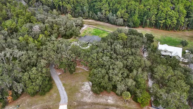 an aerial view of residential house with outdoor space and swimming pool