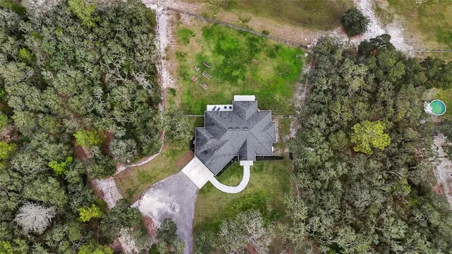 an aerial view of a house with outdoor space
