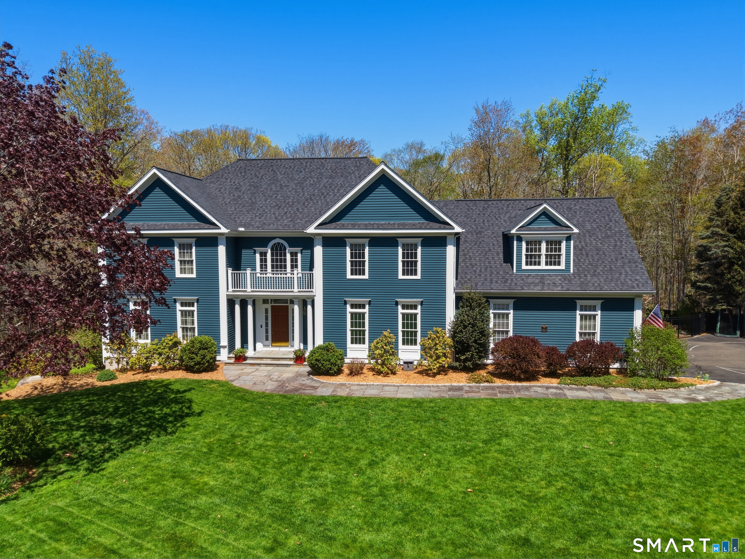 7 Timber Lane Guilford, CT 06437 - Photo 1 of 40 a front view of a house with garden and trees
