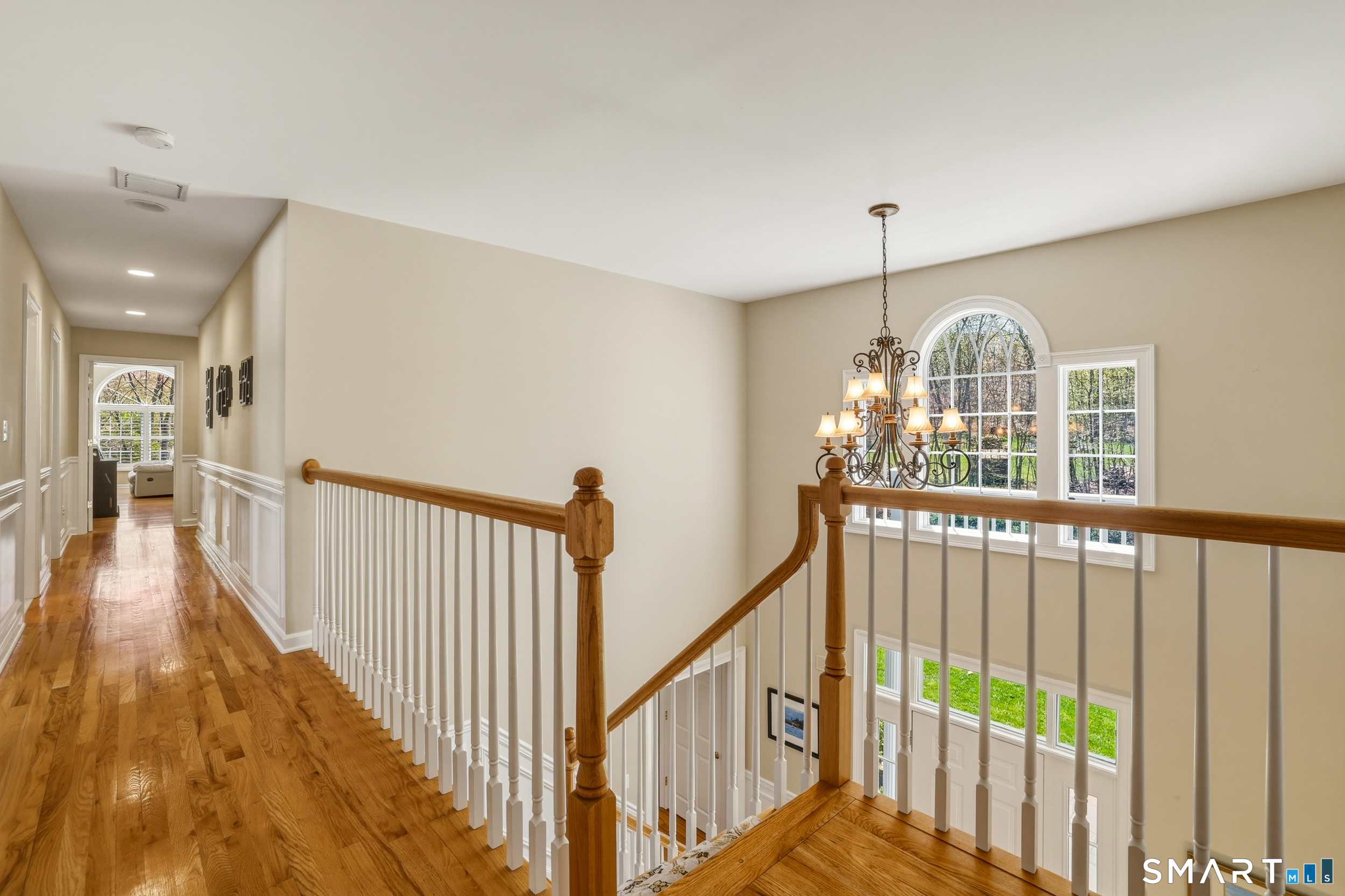 7 Timber Lane Guilford, CT 06437 - Photo 13 of 40 a view of a hallway with wooden floor and stairs