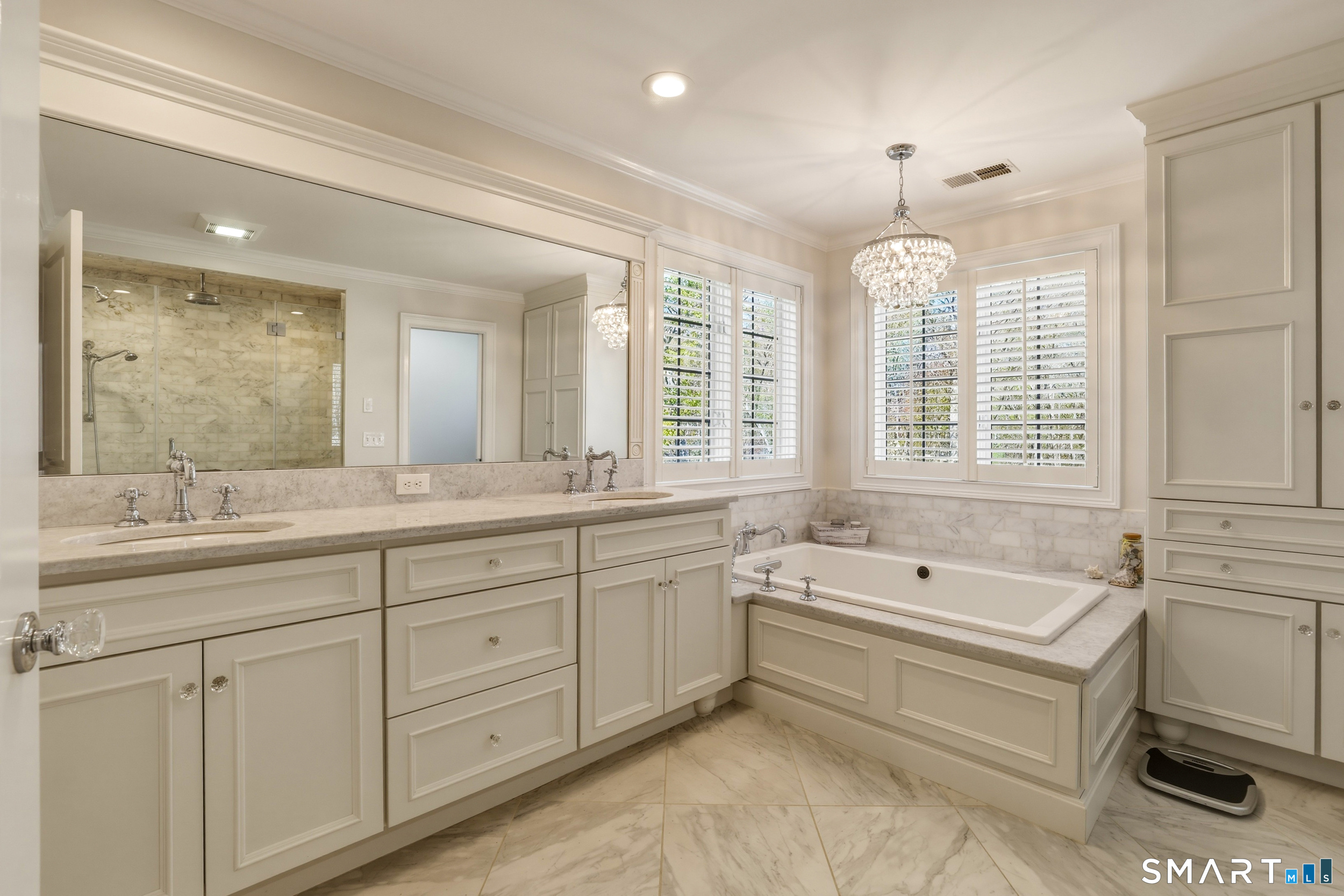 7 Timber Lane Guilford, CT 06437 - Photo 15 of 40 a spacious bathroom with a double vanity sink a large mirror and a bathtub
