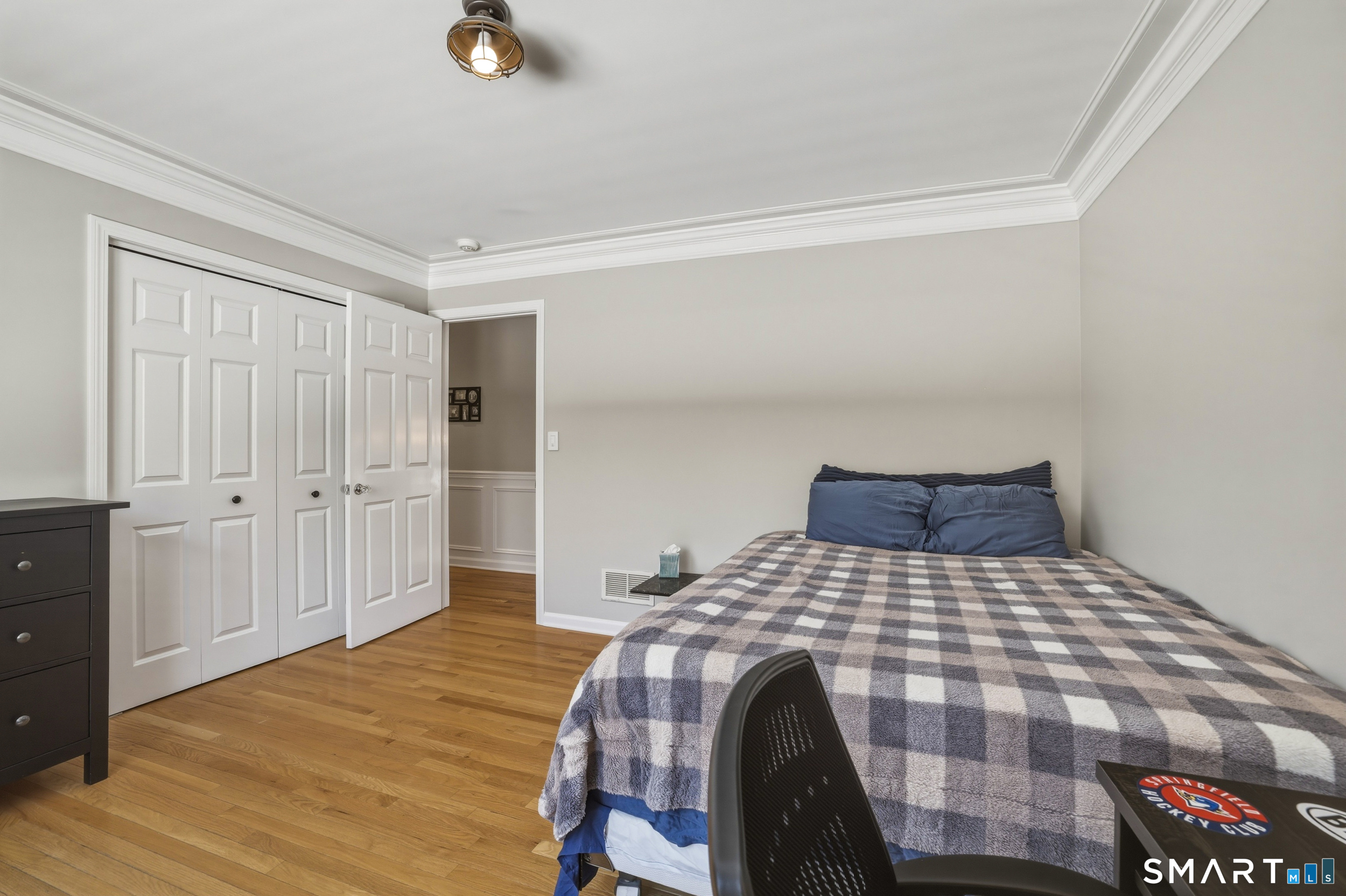 7 Timber Lane Guilford, CT 06437 - Photo 20 of 40 a bedroom with a bed and wooden floor