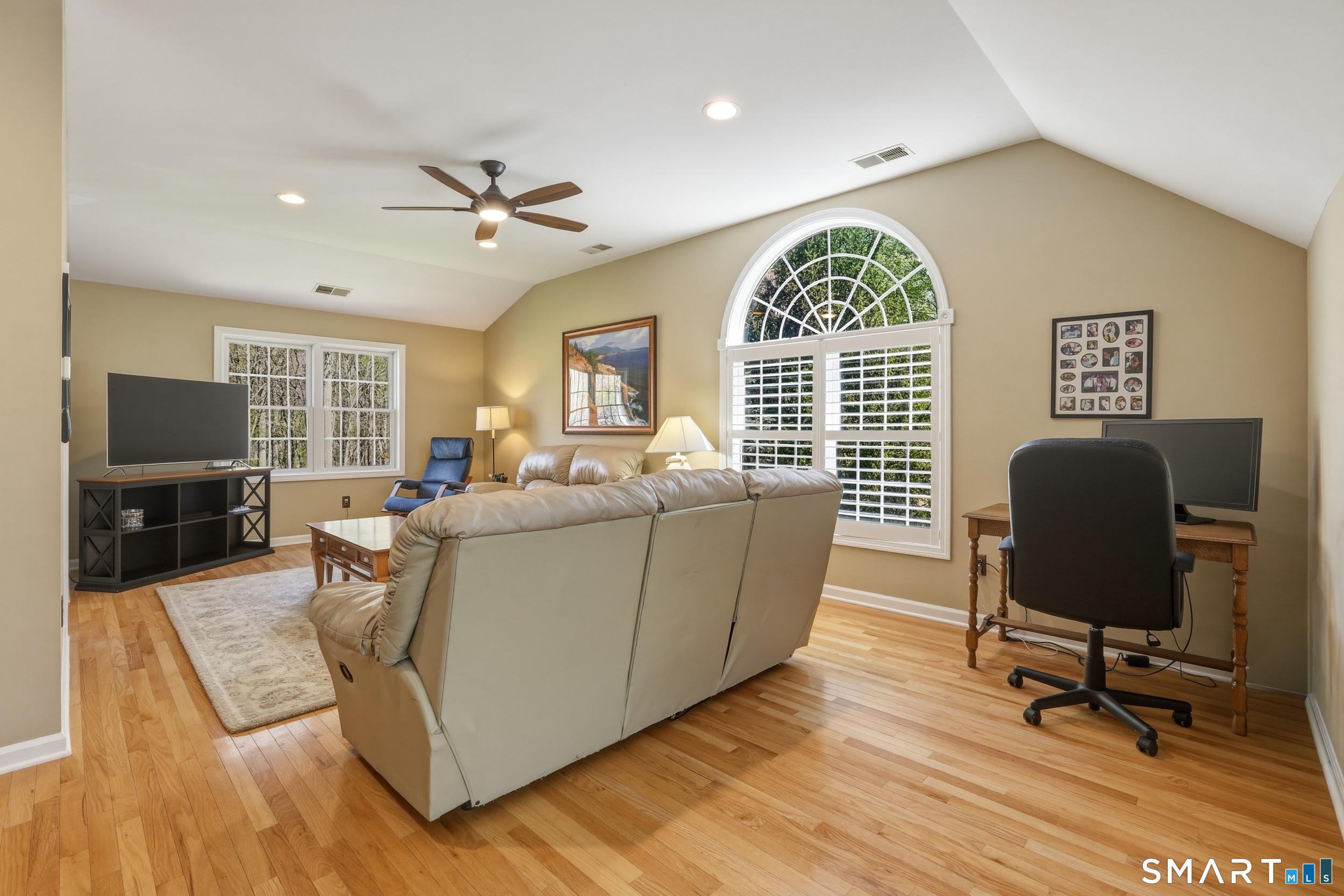 7 Timber Lane Guilford, CT 06437 - Photo 24 of 40 a living room with furniture a window and a flat screen tv