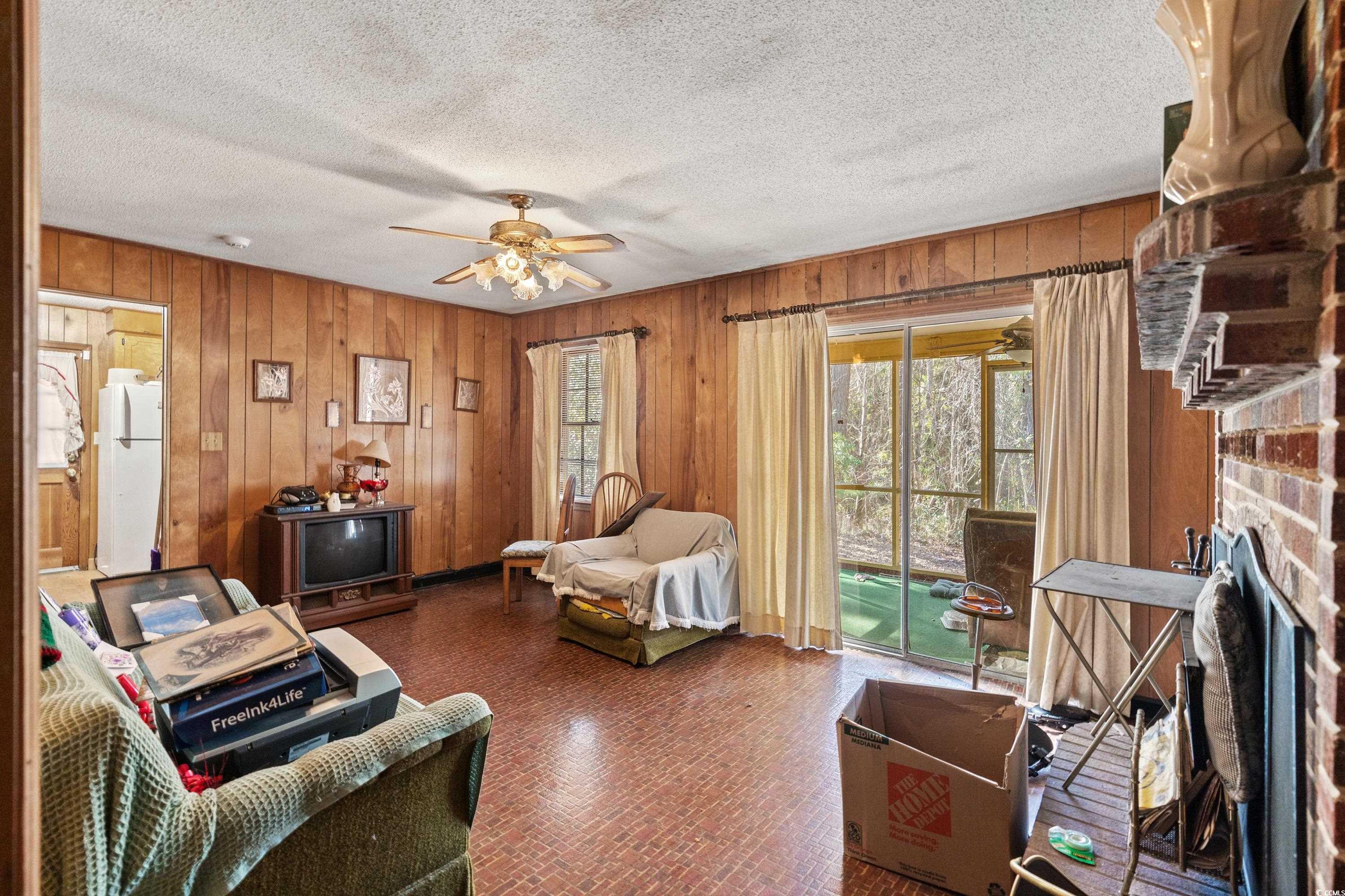 3592 South Island Road Georgetown, SC 29440 - Photo 4 of 24 Living area featuring a ceiling fan, brick floor,