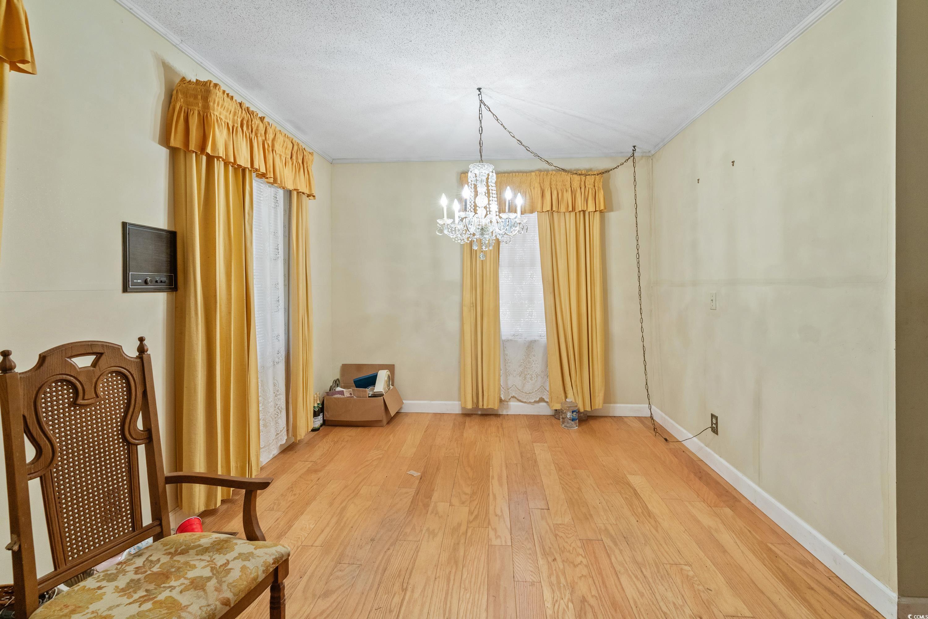 3592 South Island Road Georgetown, SC 29440 - Photo 6 of 24 Unfurnished dining area with an inviting chandelie