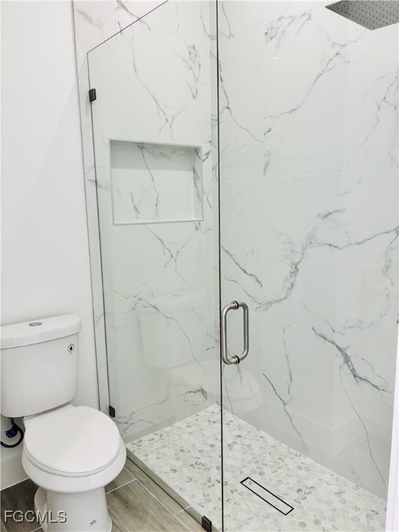 3010 45th Street Southwest Lehigh Acres, FL 33976 - Photo 14 of 29 a bathroom with a toilet and a shower